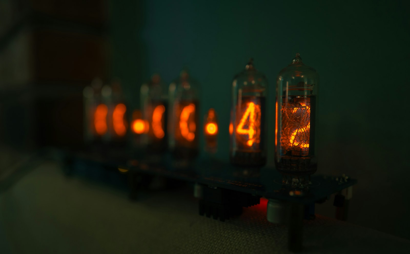 Vintage nixie tube clock displays glowing orange numbers