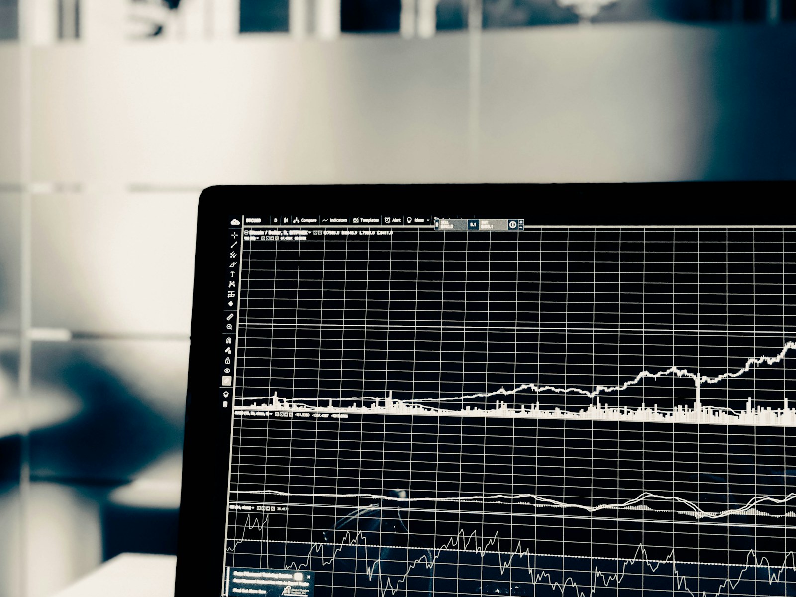 A computer screen displaying a white line graph of financial market data