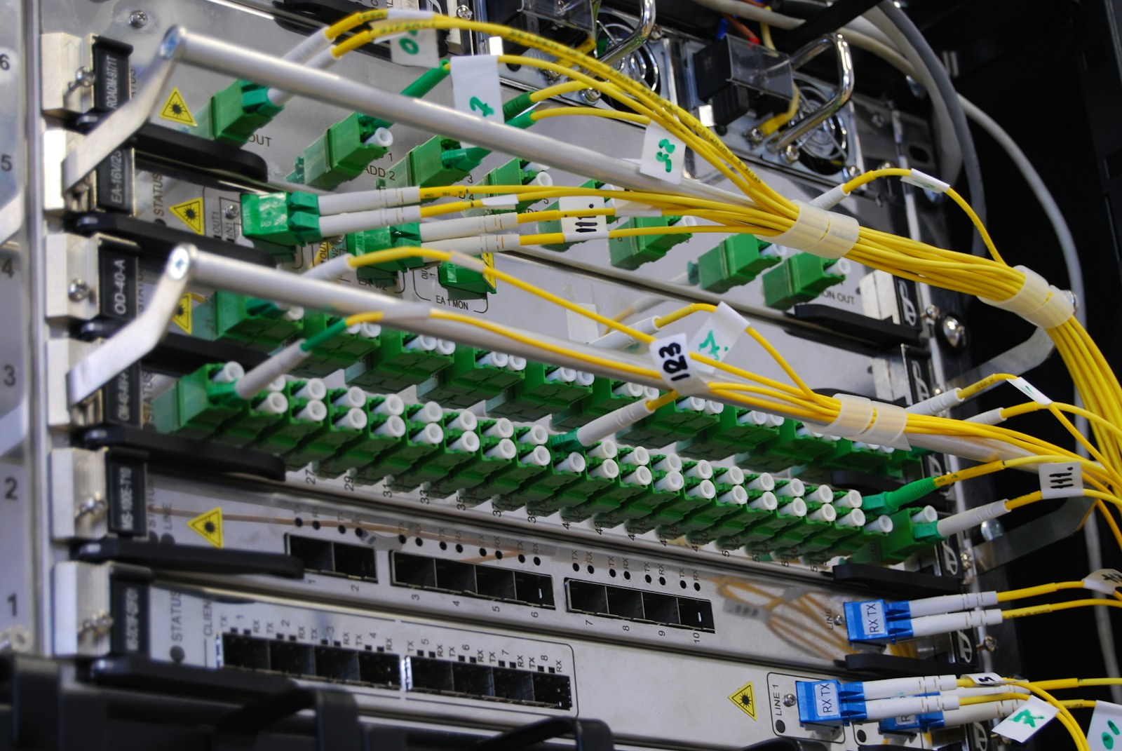 Fiber optic cables connected to a network switch in a server rack