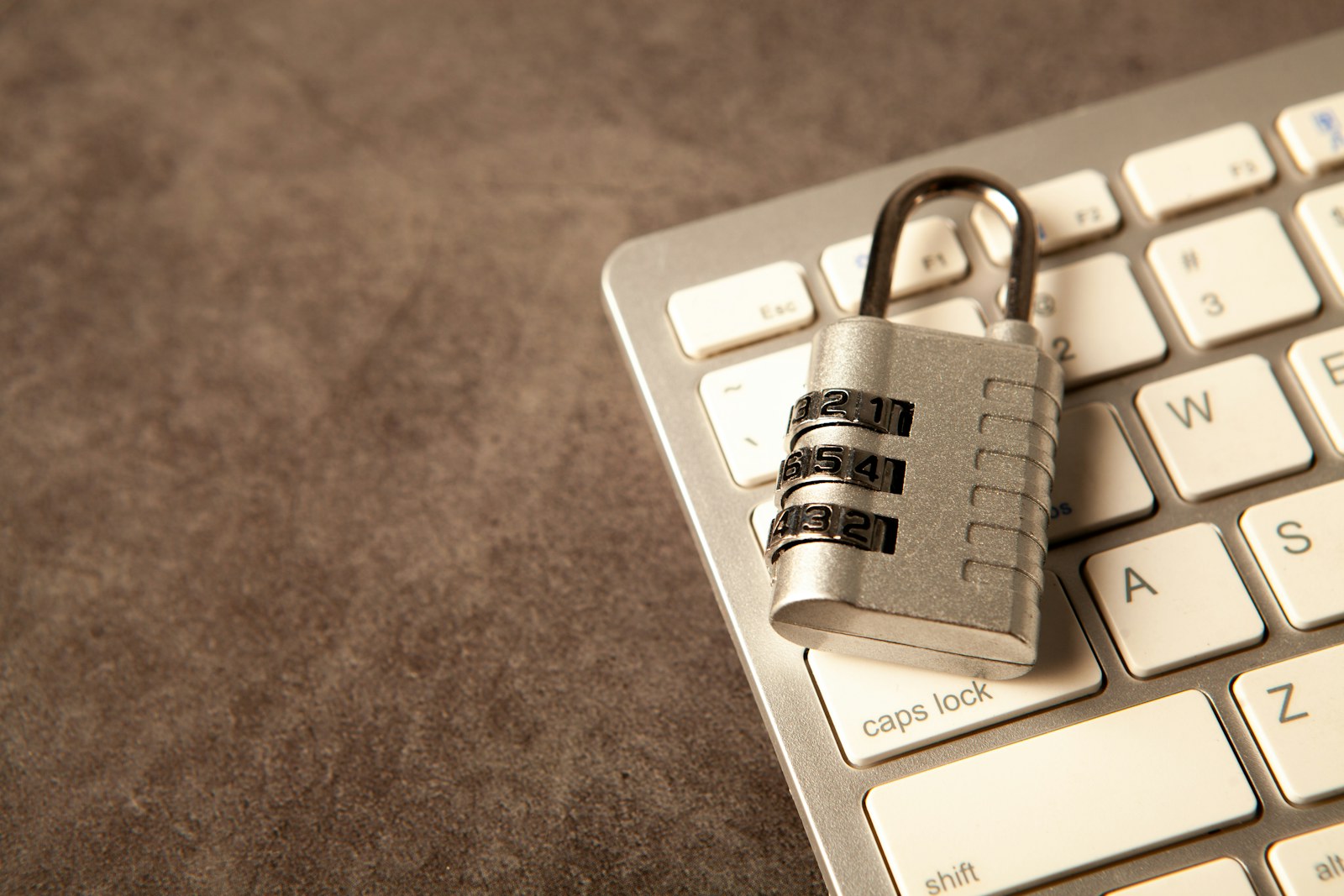 A padlock rests on a computer keyboard