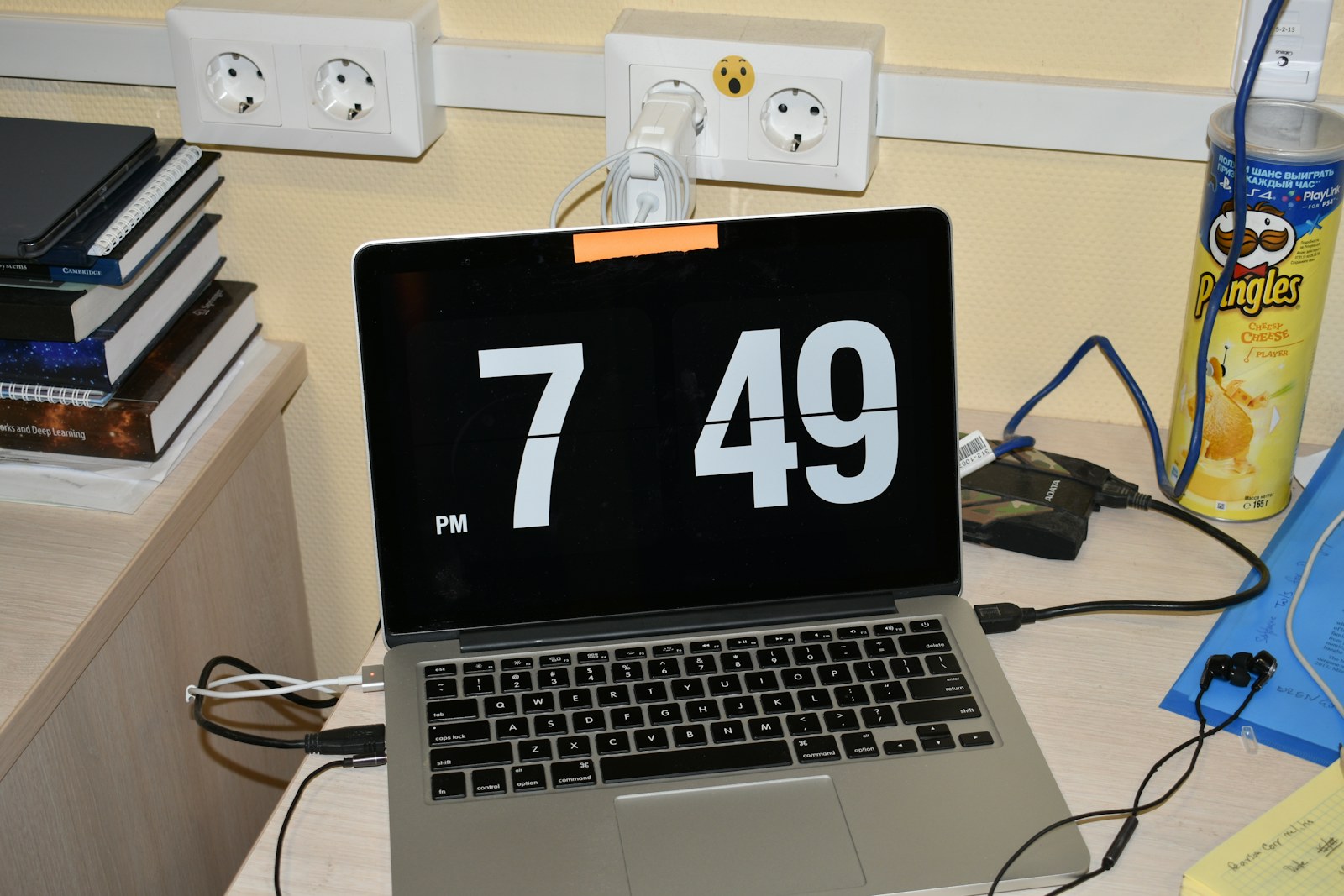 Laptop displaying a digital clock on a desk