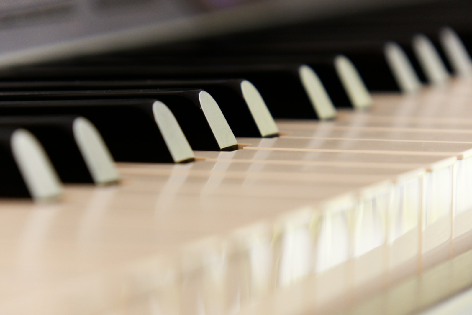 A close-up of shiny black and white piano keys