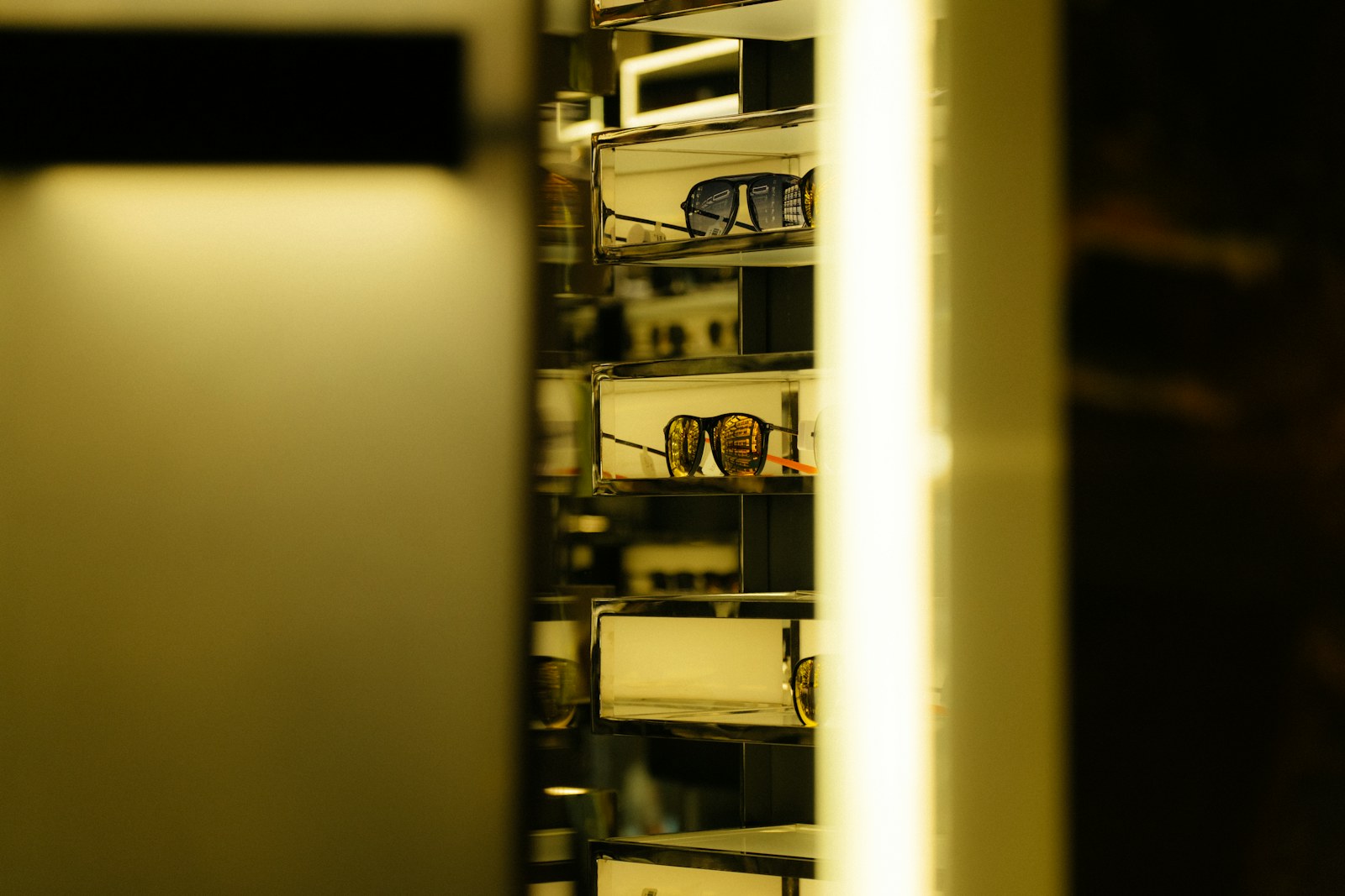 Sunglasses displayed on shelves in a store