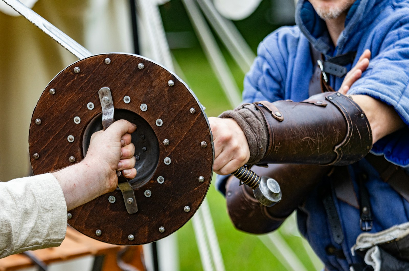 two men shaking hands over a wooden object