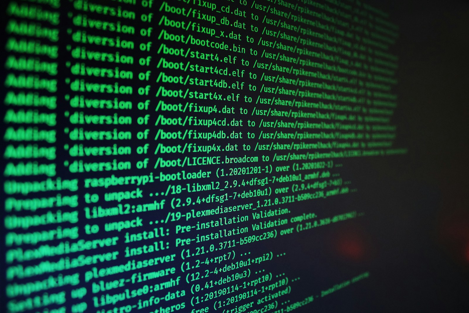 Green computer code text scrolling on a dark screen during a software installation