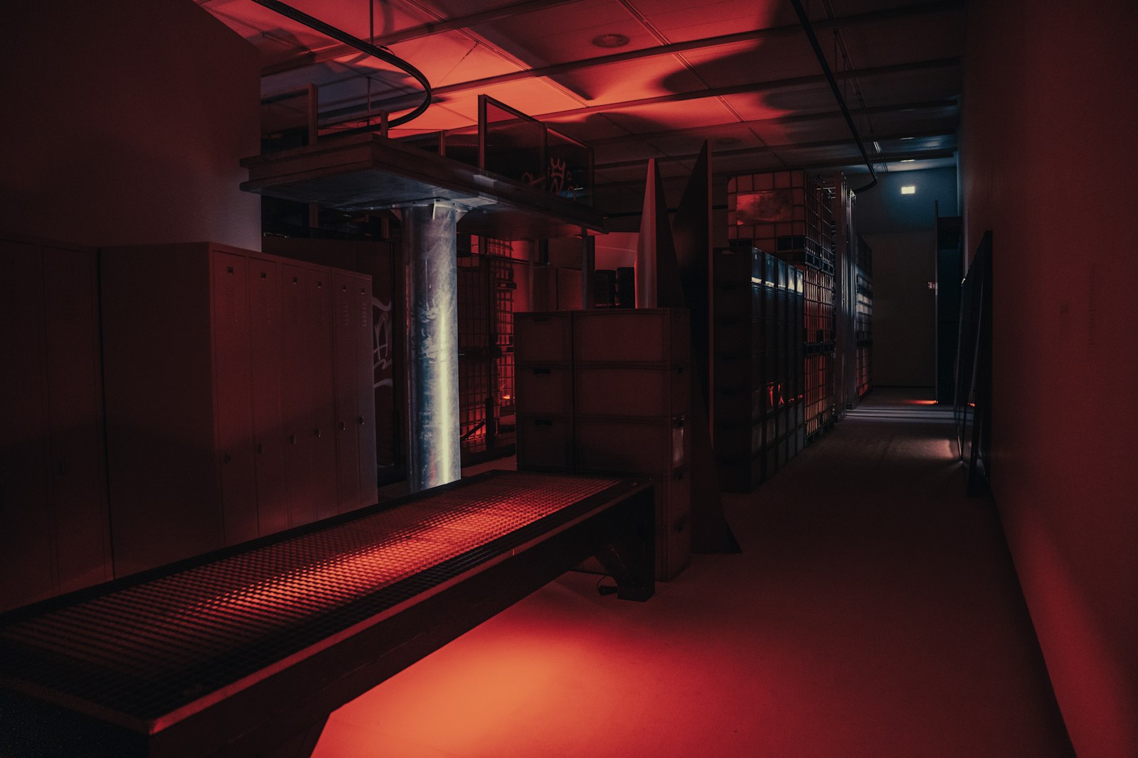 a dimly lit room with a bench in the middle