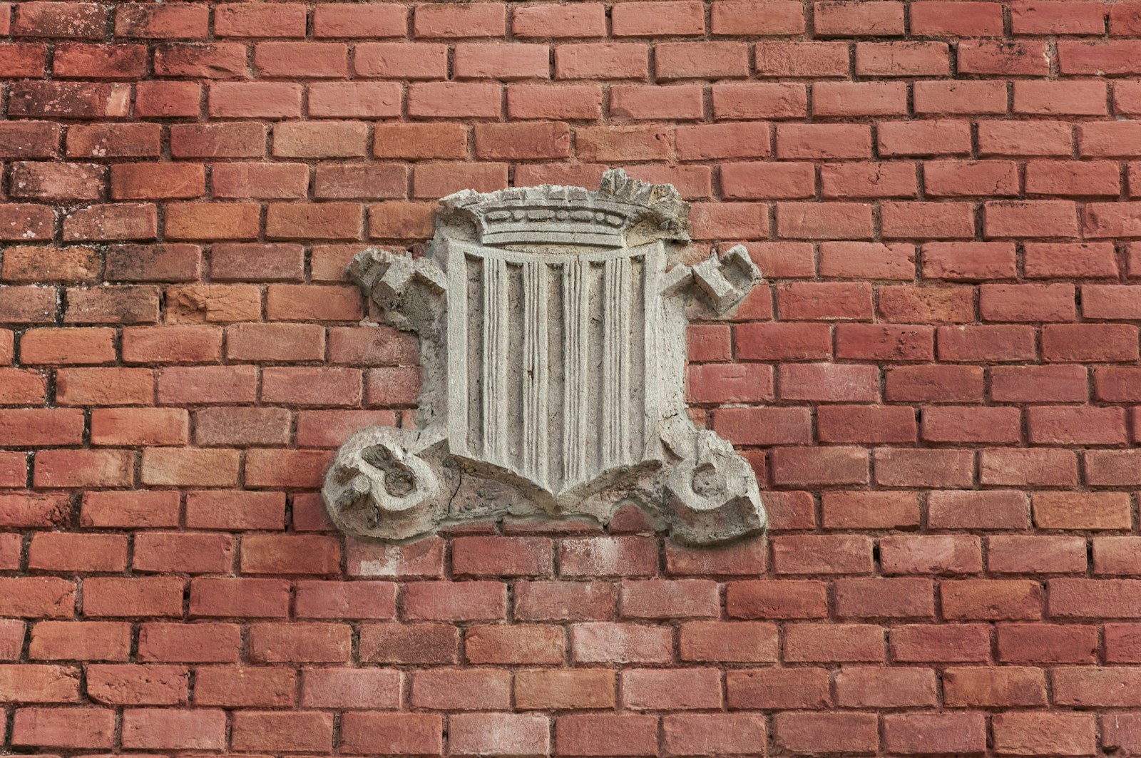 a brick wall with a decorative window on it