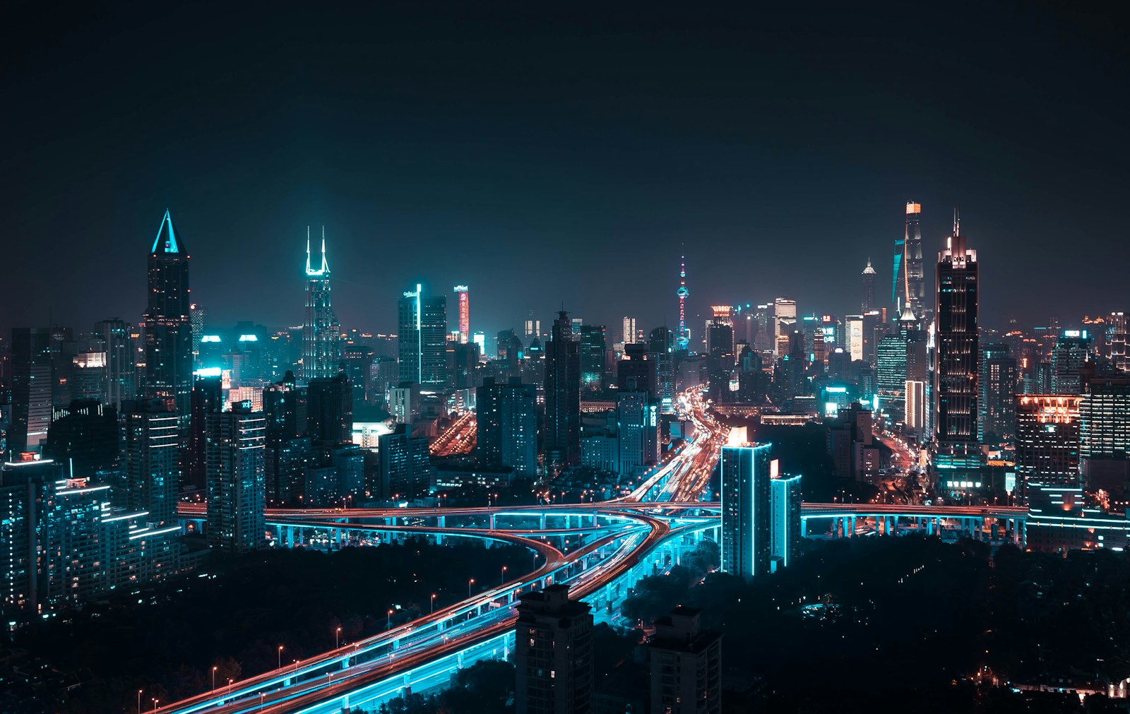 Illuminated skyscrapers and elevated highways at night in the city of Shanghai