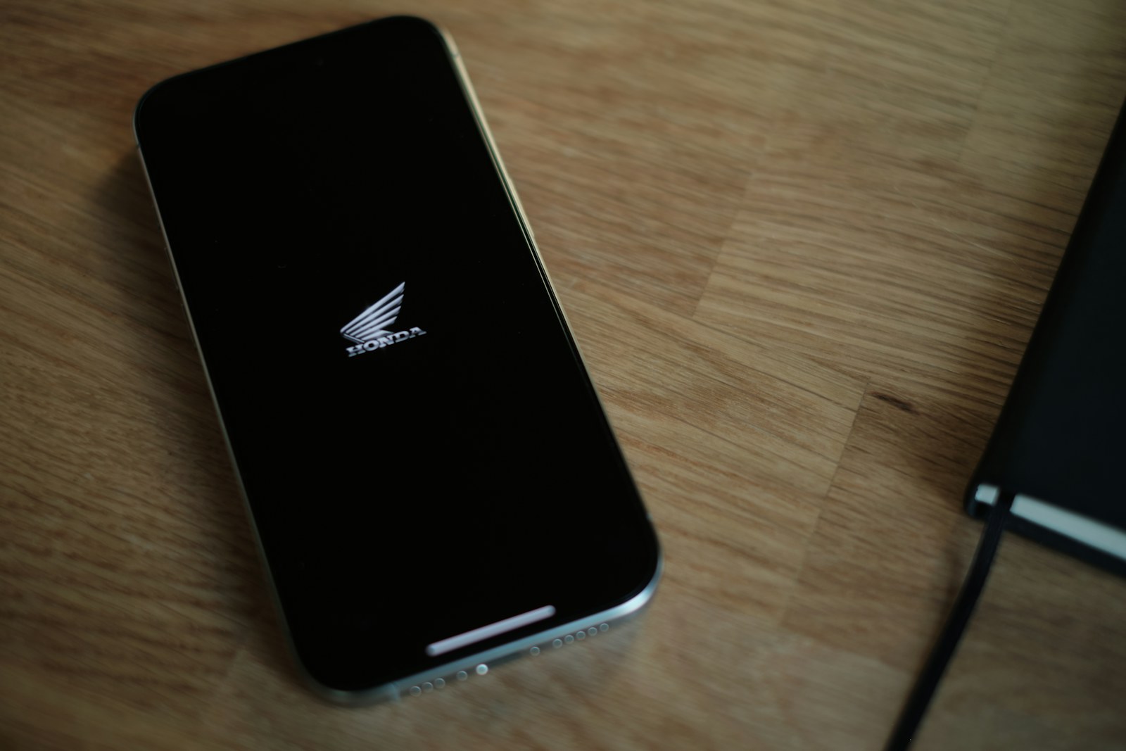 A cell phone sitting on top of a wooden table