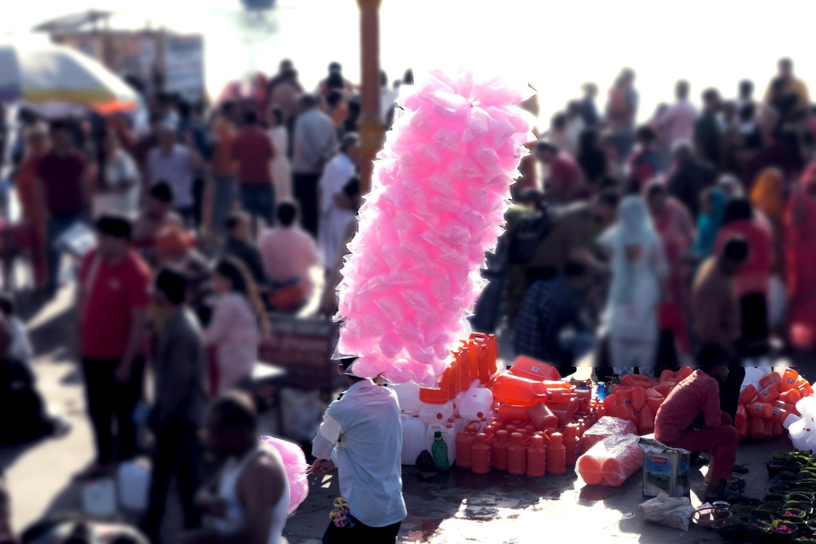 A large pink object is in the middle of a crowd