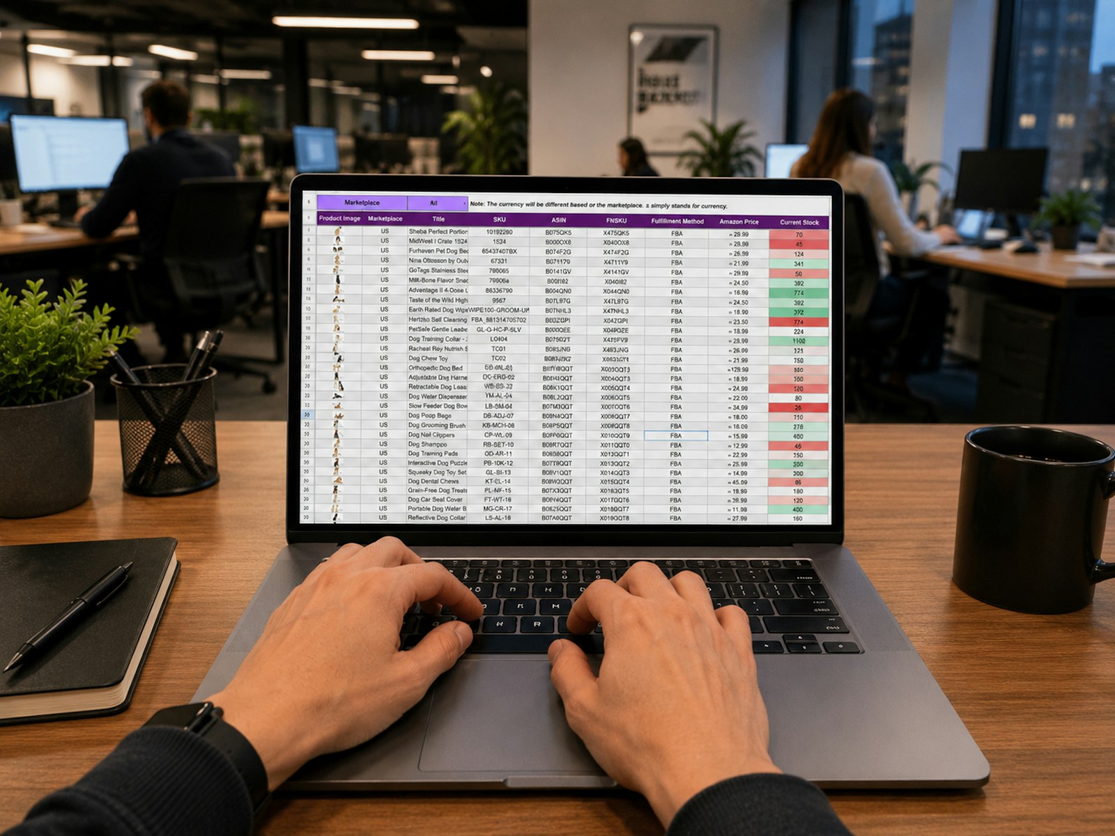 Hands typing on a laptop displaying a data spreadsheet