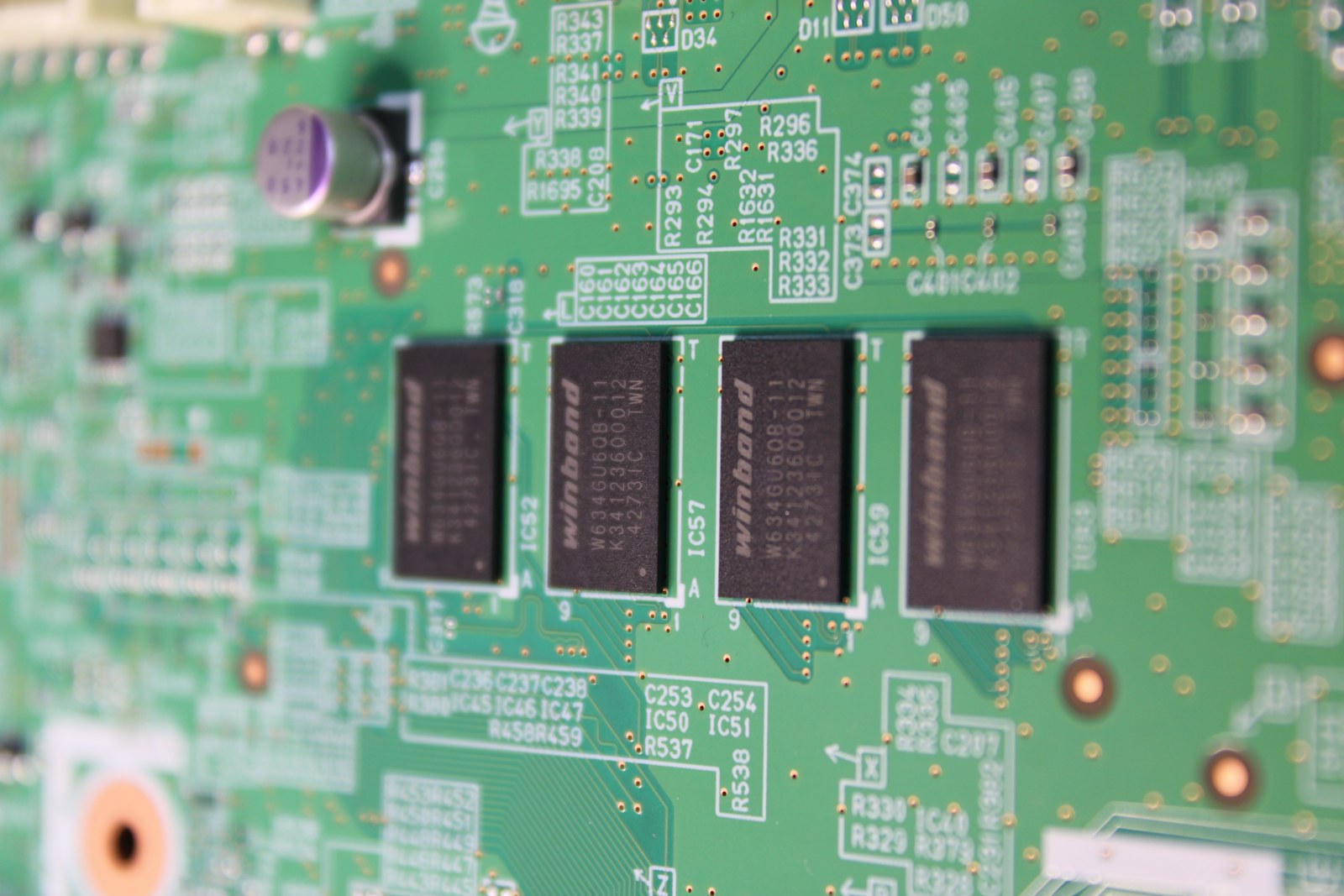 Close-up of integrated circuits on a green circuit board
