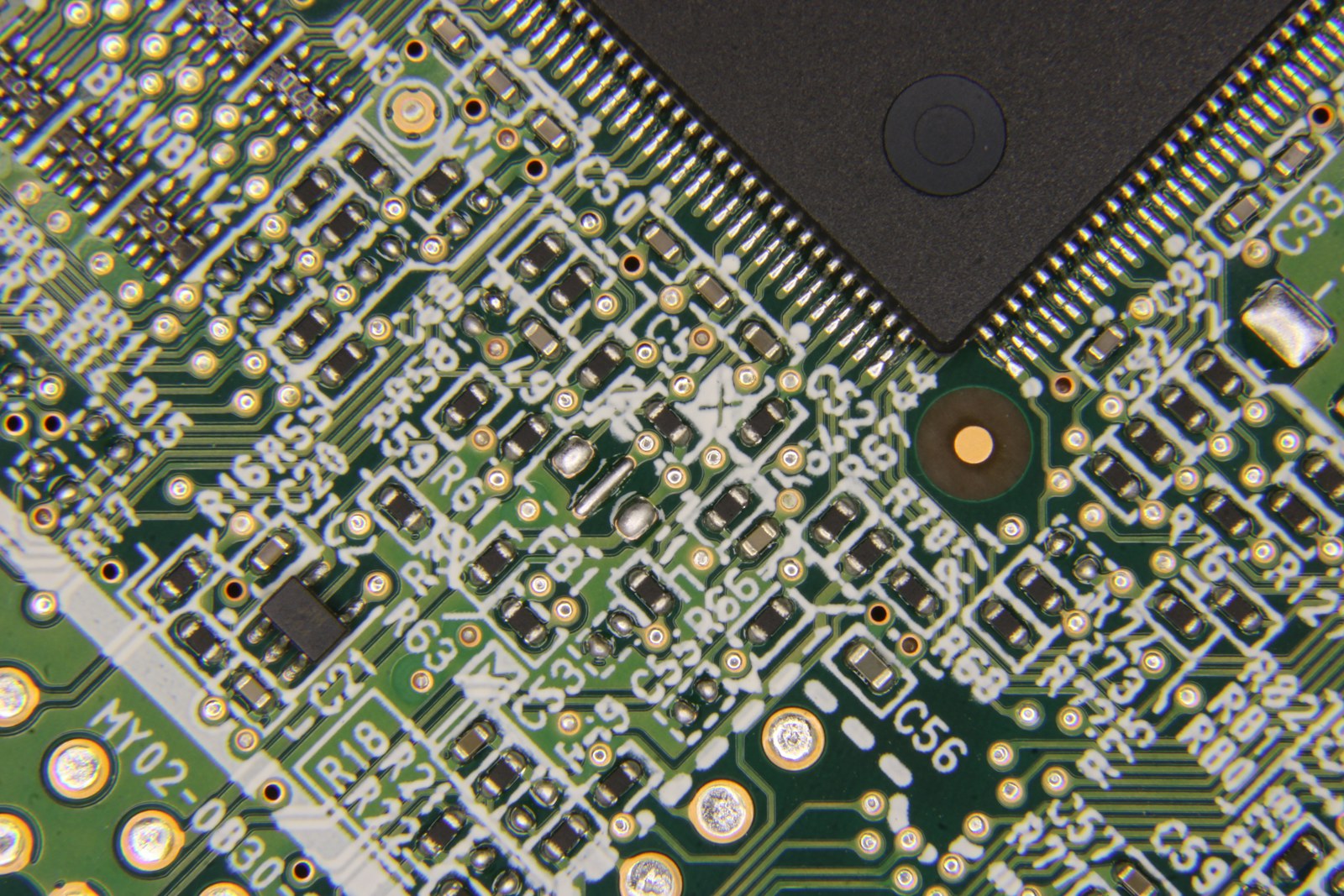 Close-up of a green circuit board with electronic components
