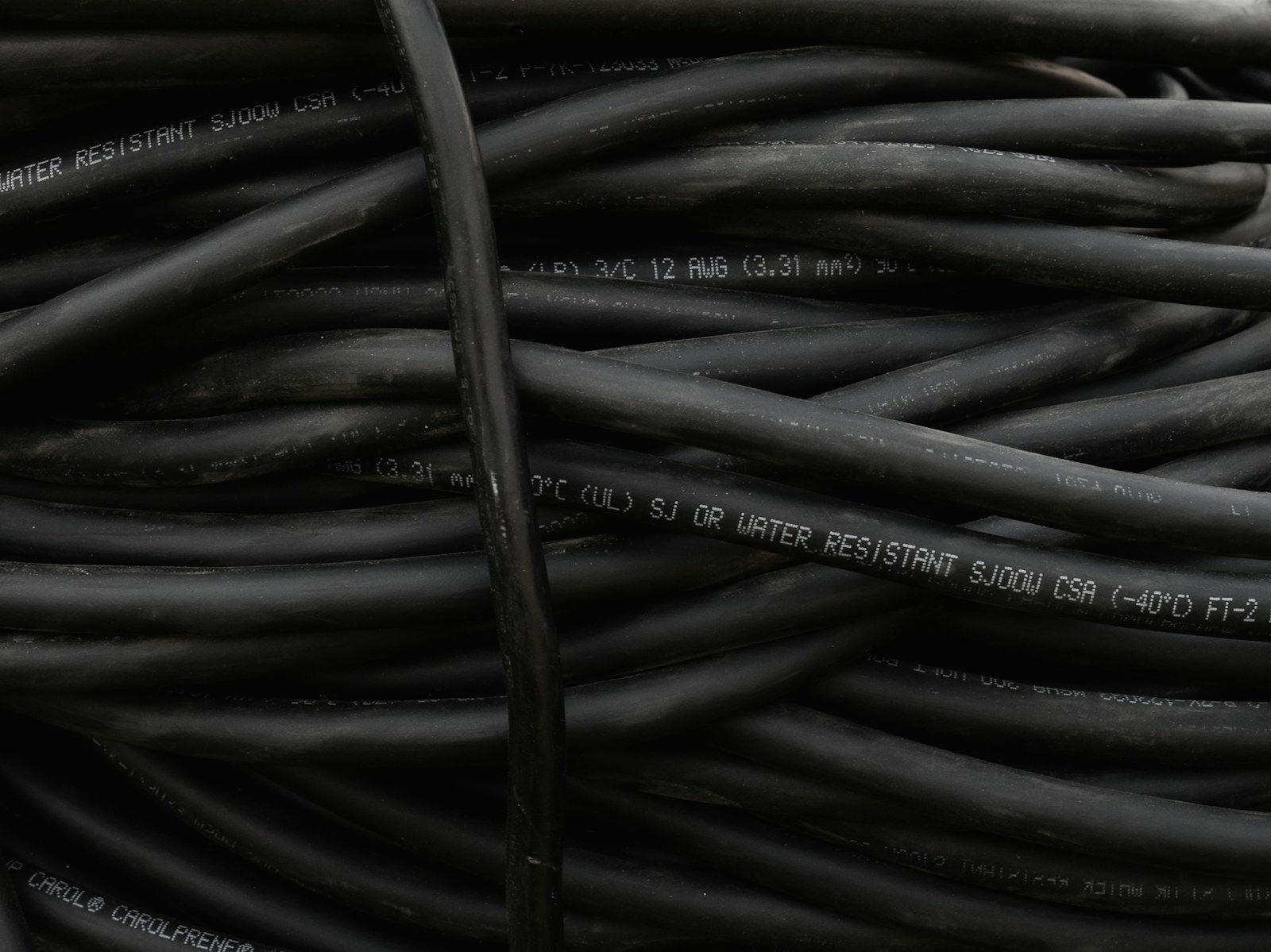 a bunch of black wires are stacked together