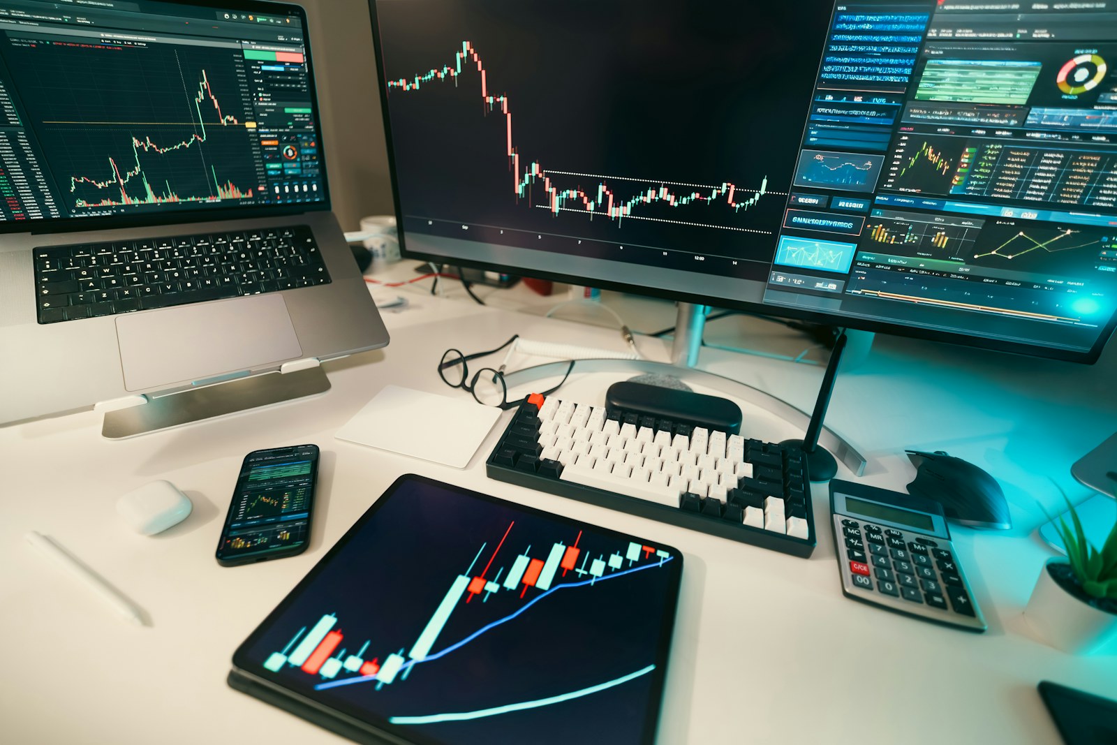 Stock charts are displayed on multiple screens