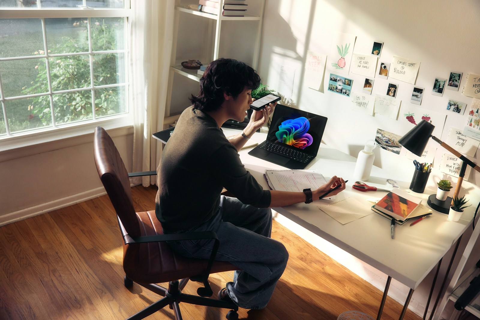 Person working at a desk with a laptop and books