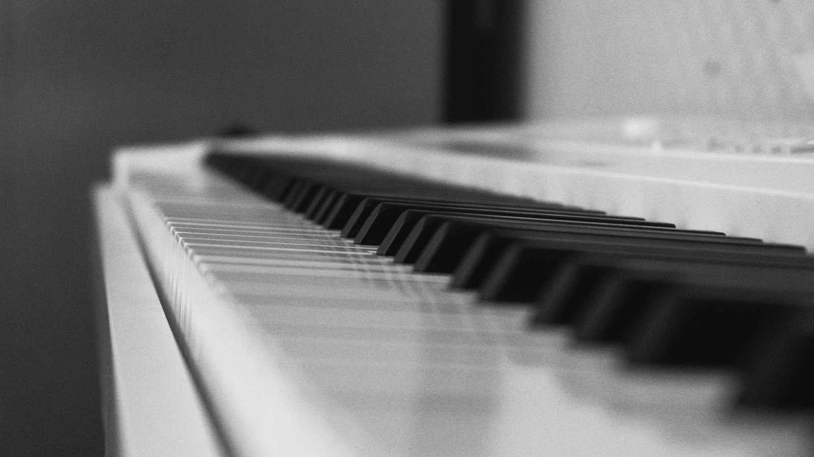 Close-up of a piano keyboard in black and white