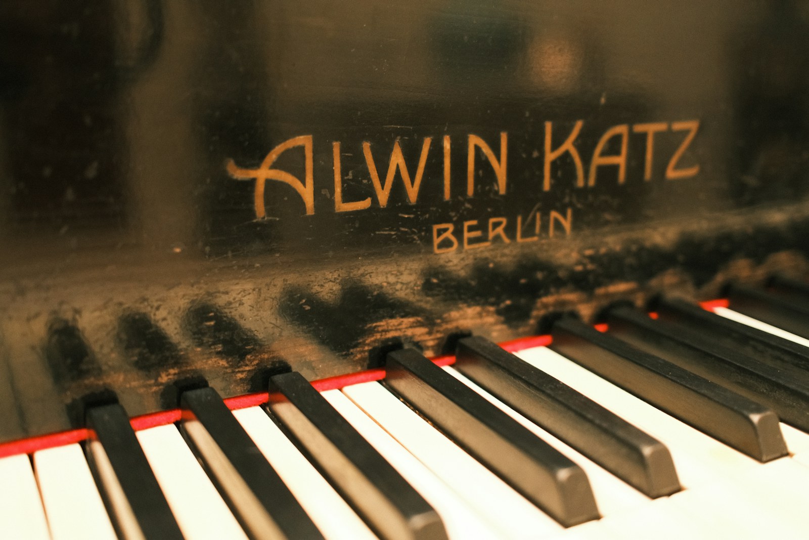 Dusty old piano keys with 'alwin katz berlin' visible
