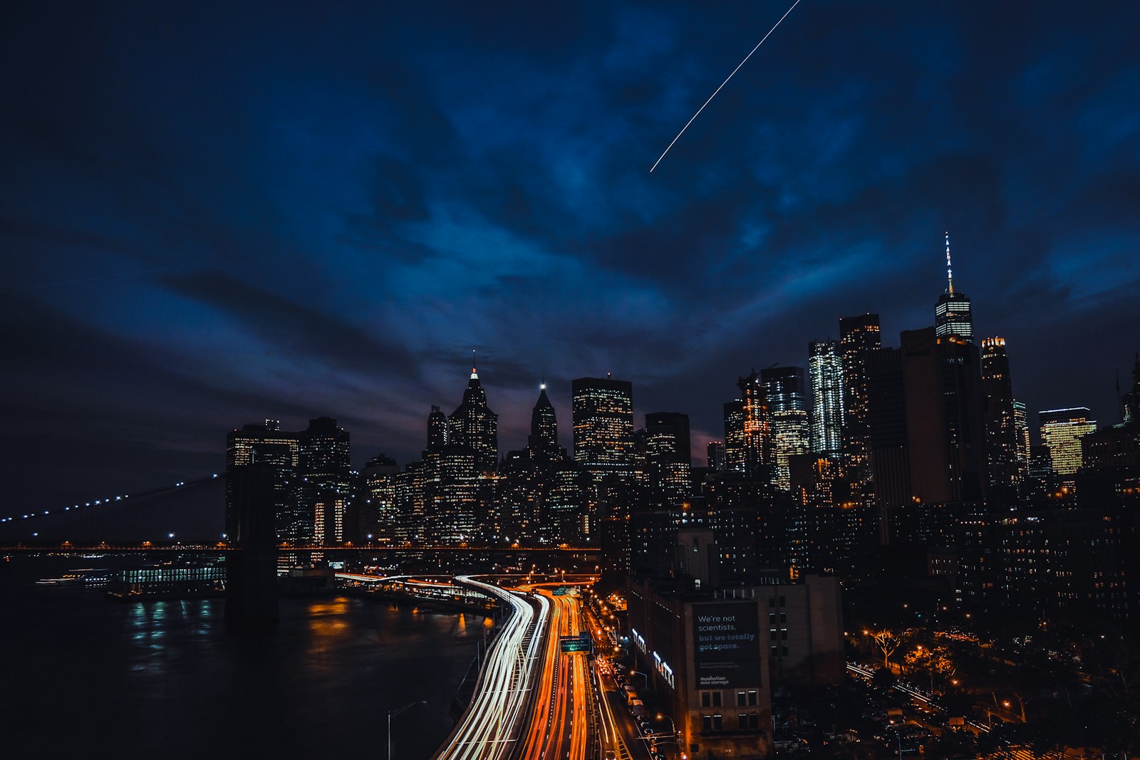 Long exposure light trails on a highway before the New York City skyline